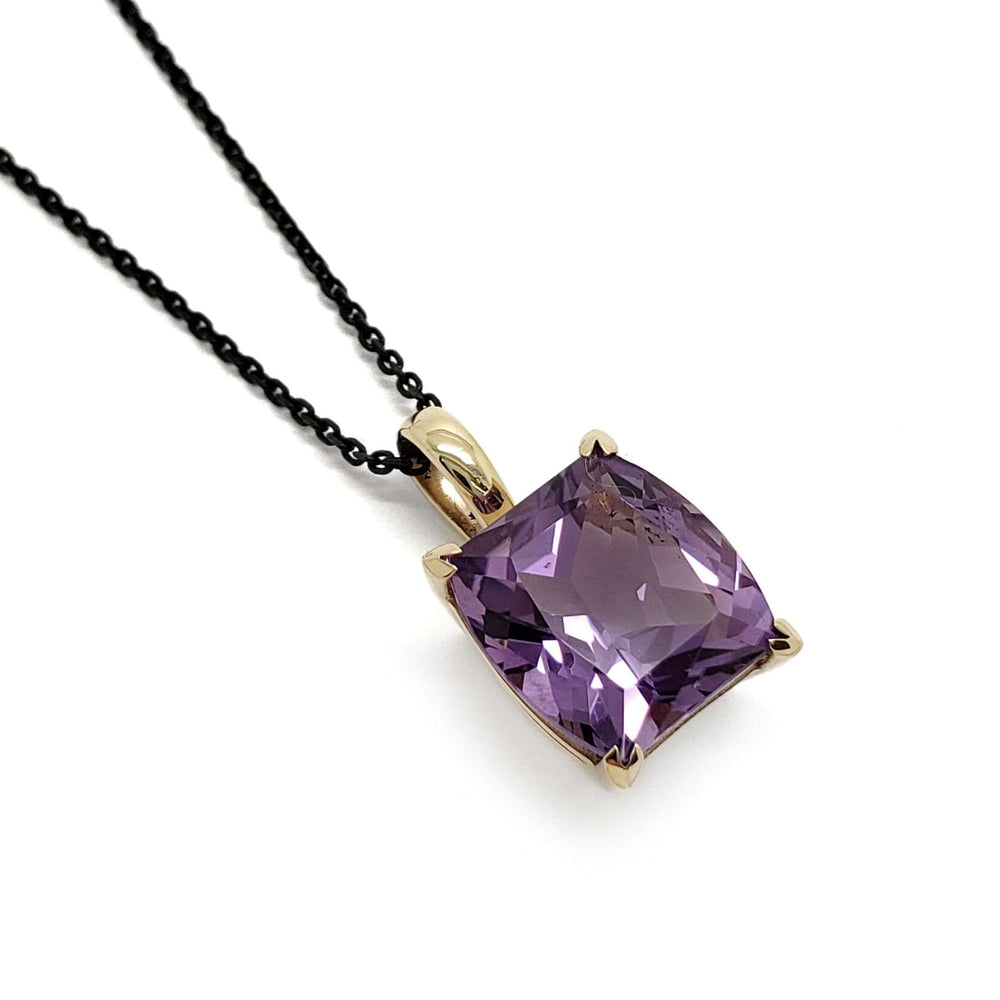 14kt yellow gold pendant with a barrel-cut purple amethyst on a black chain