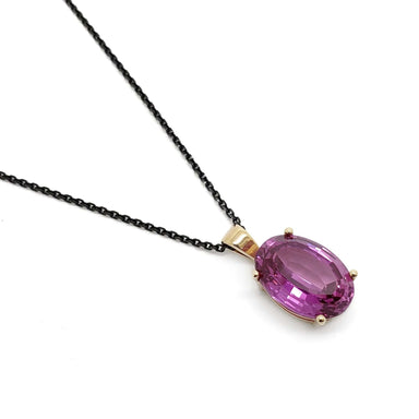14kt yellow gold pendant with oval lab-grown pink sapphire on a black chain