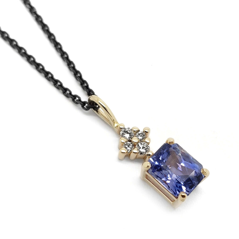 14kt yellow gold pendant with radiant blue sapphire and cluster of lab diamonds on black chain