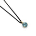 14kt yellow gold pendant with round blue zircon on a black chain, angled view