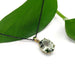 14kt yellow gold prasiolite pendant on black chain, styled with green leaf