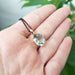 14kt yellow gold prasiolite pendant with soft green gemstone shown in hand