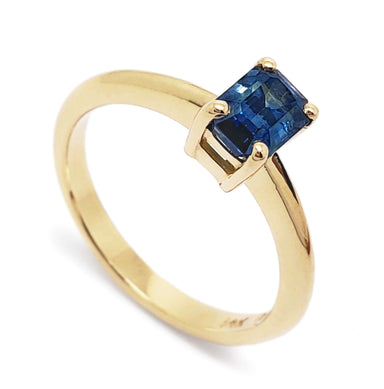 14kt yellow gold ring with emerald cut blue Montana sapphire in claw setting