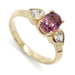 14kt yellow gold ring with oval pink sapphire and two heart-shaped lab diamonds