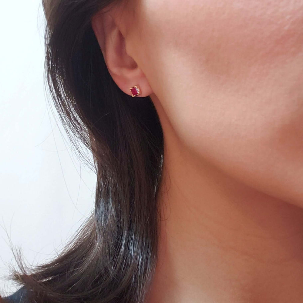 Square lab ruby stud earring in 14kt yellow gold worn on ear