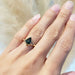 14kt yellow gold teal sapphire engagement ring worn on hand, natural light