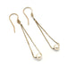 Pair of teardrop earrings in 14kt yellow gold with freshwater pearls on white background