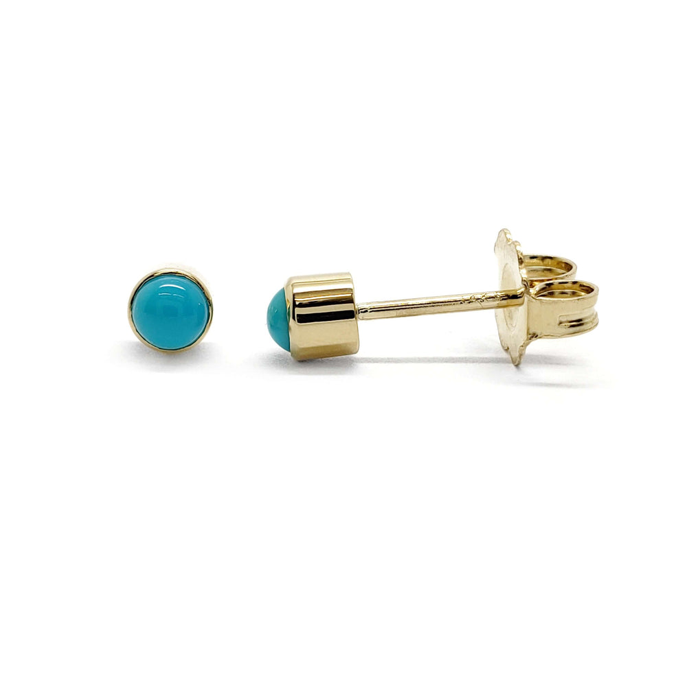 Pair of 14kt yellow gold stud earrings with round turquoise cabochons on white background