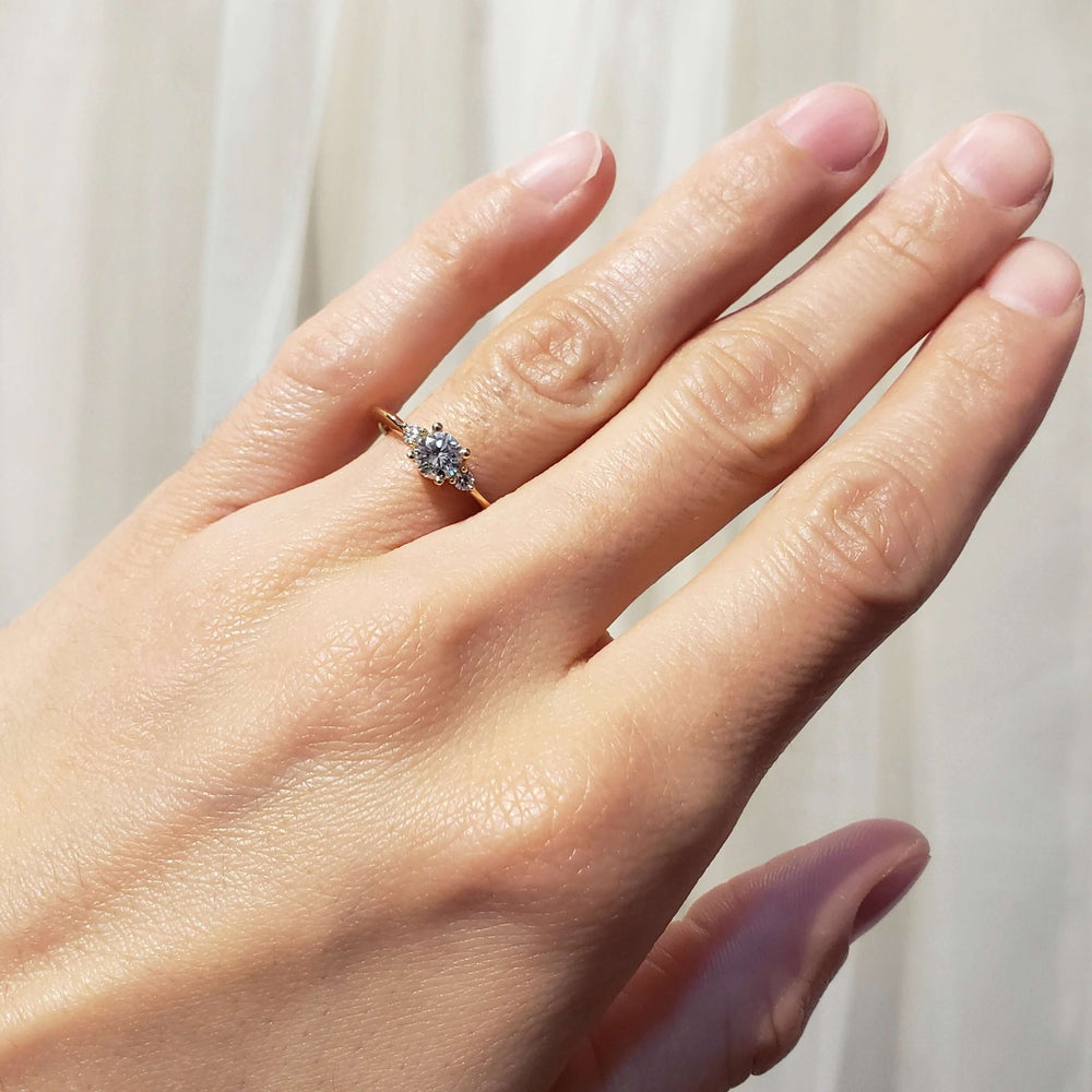 14kt yellow gold vintage diamond engagement ring worn on hand, showing delicate band