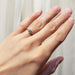 14kt yellow gold vintage diamond engagement ring worn on hand, showing delicate band