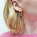Vintage-inspired 14kt yellow gold garnet dangle earring worn on ear