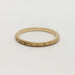 14kt yellow gold wedding band with wheat hand engraving on white background