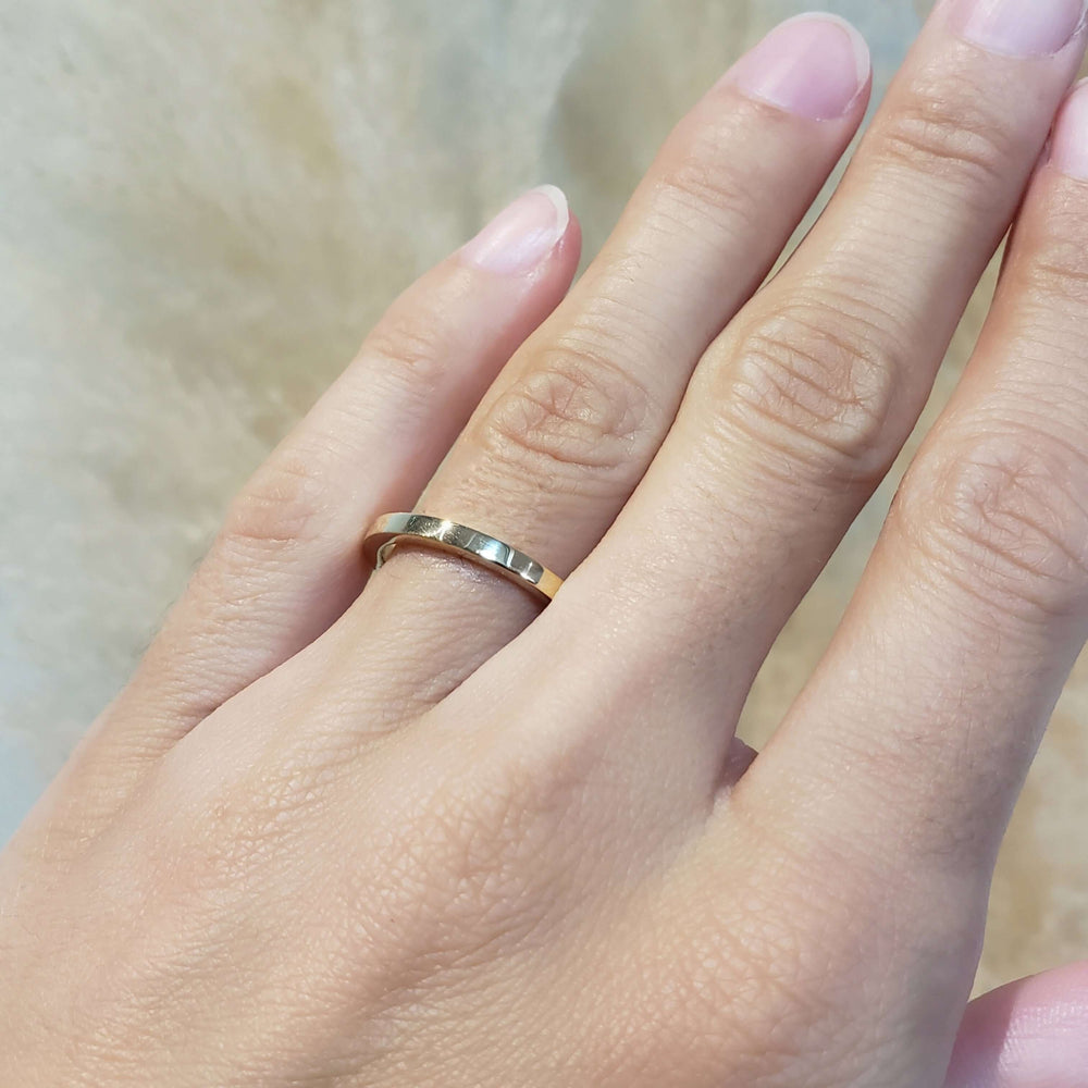 14kt yellow gold wedding ring worn on hand
