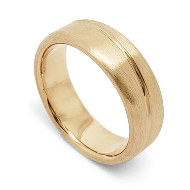 14kt yellow gold wedding ring with brushed finish and asymmetrical carved line