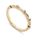 14kt yellow gold wedding ring with textured leaf details and bezel set diamonds