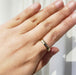 14kt yellow gold wedding ring worn on hand, showing low dome profile
