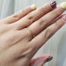 14kt yellow gold wheat engraved wedding ring shown worn on a hand