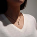 Vintage emerald and diamond pendant necklace in 18kt gold, worn on a woman's neck