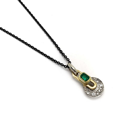 18kt yellow and white gold pendant with emerald and diamonds on a black chain, geometric design
