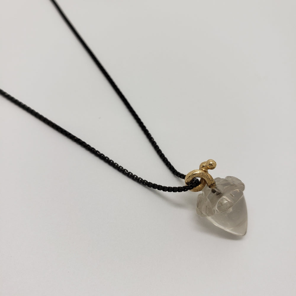 A clear, acorn-shaped quartz pendant on a delicate black chain with a small gold bail, displayed on a clean white background.