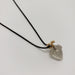 A clear, acorn-shaped quartz pendant on a delicate black chain with a small gold bail, displayed on a clean white background.