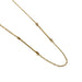 A delicate gold chain necklace featuring a central straight bar with small circular links on each end, displayed on a clean white background.