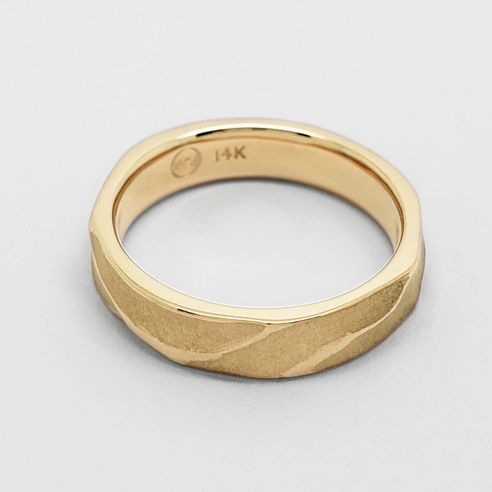 4mm topography textured yellow gold wedding band, flat lay showing inside engraving