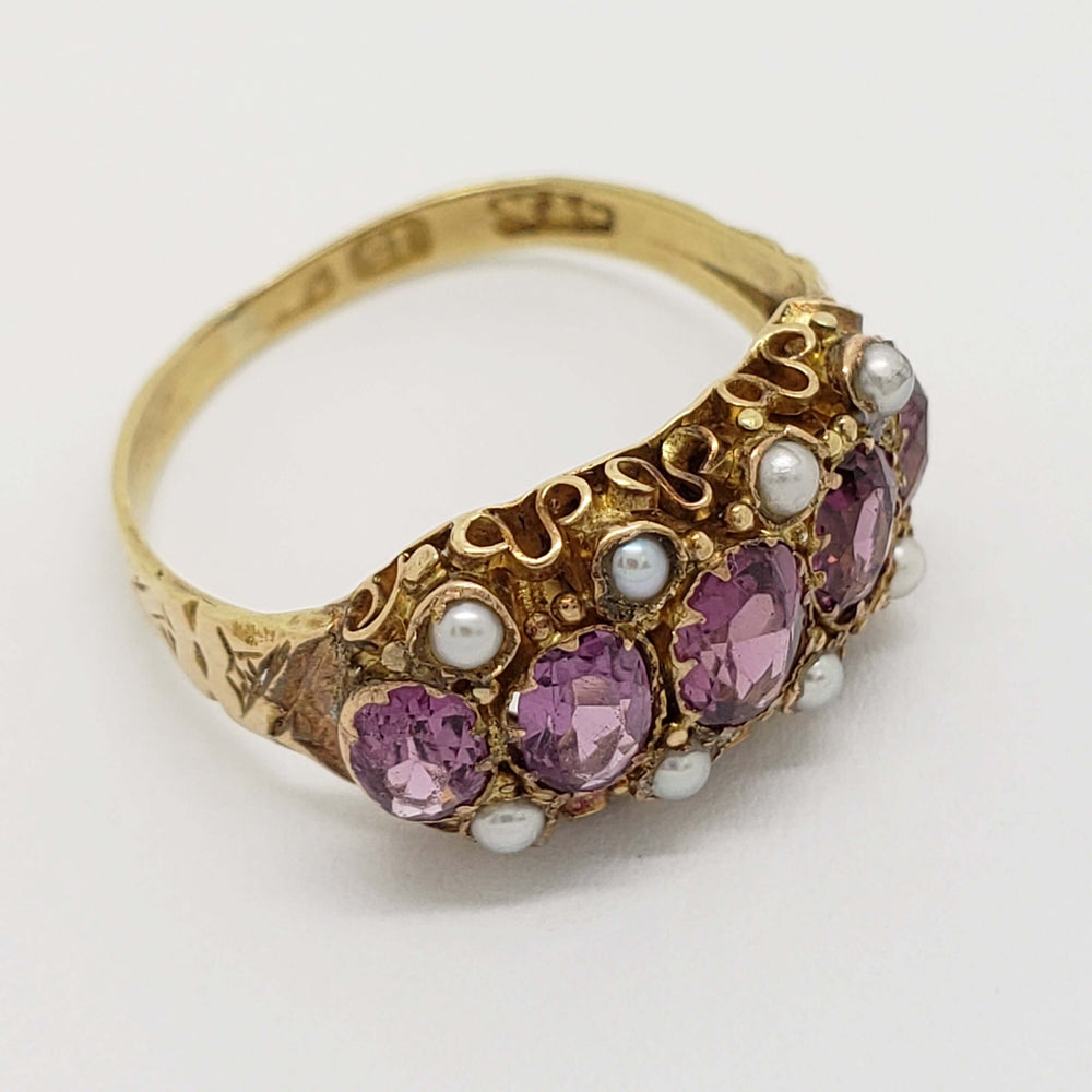 Angled view of antique 15kt yellow gold ring with purple fluorite and pearls
