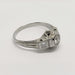 Angled view of engraved 18kt white gold diamond ring with hexagon and millgrain details