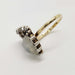 Angled view of moonstone heart ring with diamond accents and yellow gold band