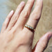 Antique 5-stone pearl ring in 15kt yellow gold, shown on hand in natural light