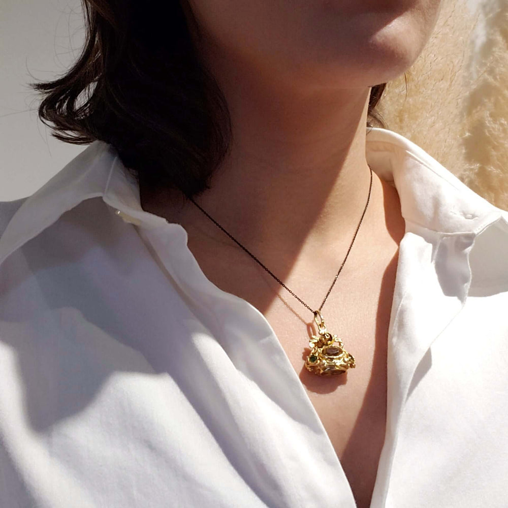Antique 18kt yellow gold citrine and peridot fob pendant worn on a black chain