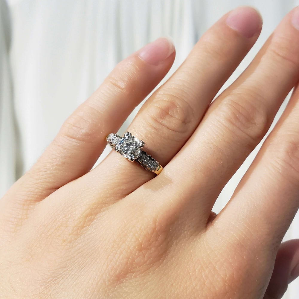 Antique diamond engagement ring in 14kt yellow and white gold shown on a hand