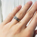 Antique diamond engagement ring in 14kt yellow and white gold shown on a hand