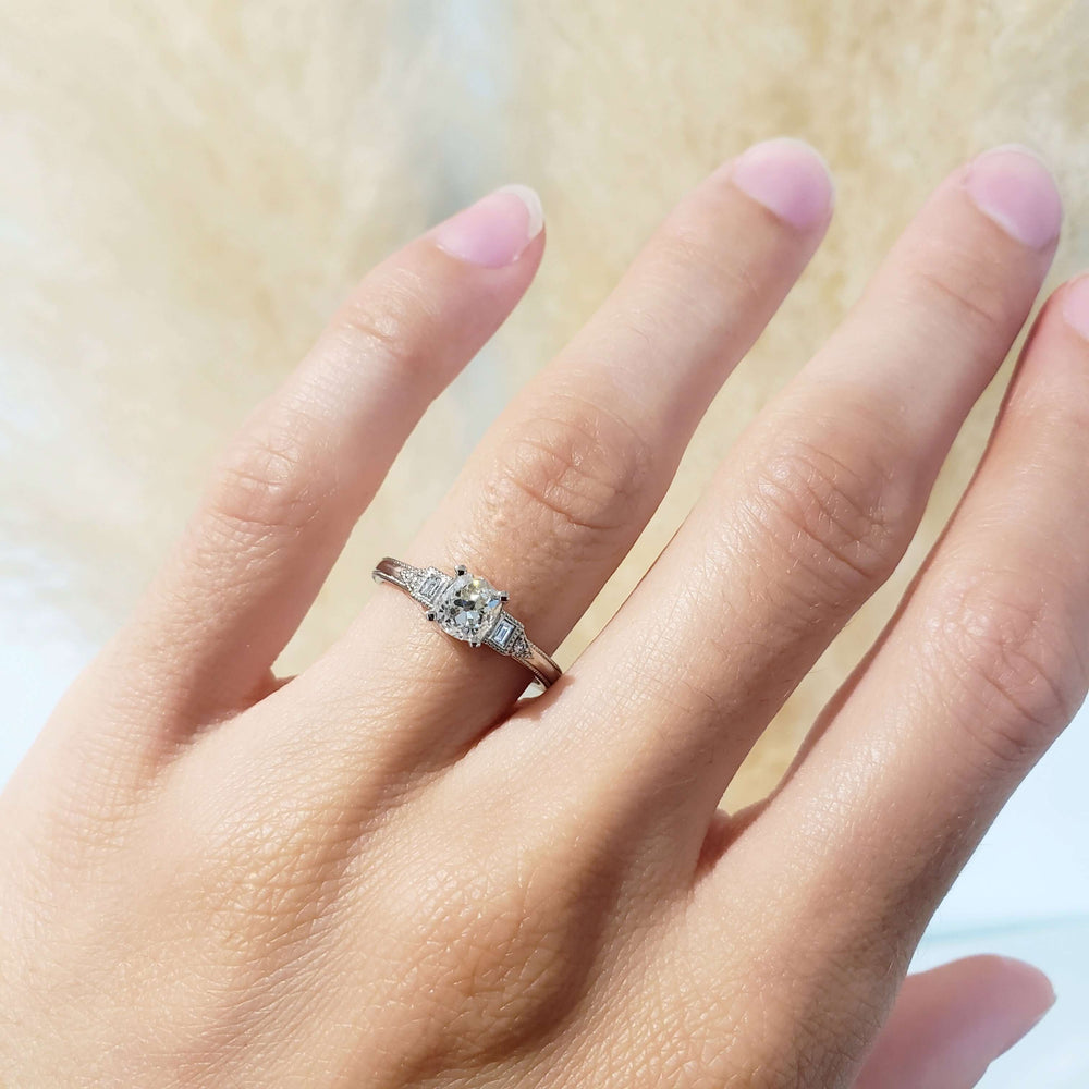 Antique diamond engagement ring in white gold shown on hand