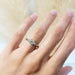 Antique diamond engagement ring in white gold shown on hand