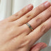 Antique diamond ring in yellow and white gold shown on hand