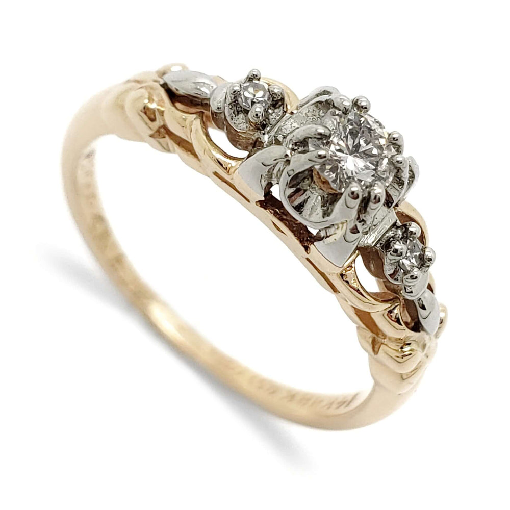 Antique diamond ring in two-tone yellow and white gold with three diamonds in ornate setting