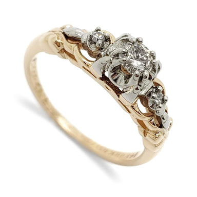 Antique diamond ring in two-tone yellow and white gold with three diamonds in ornate setting