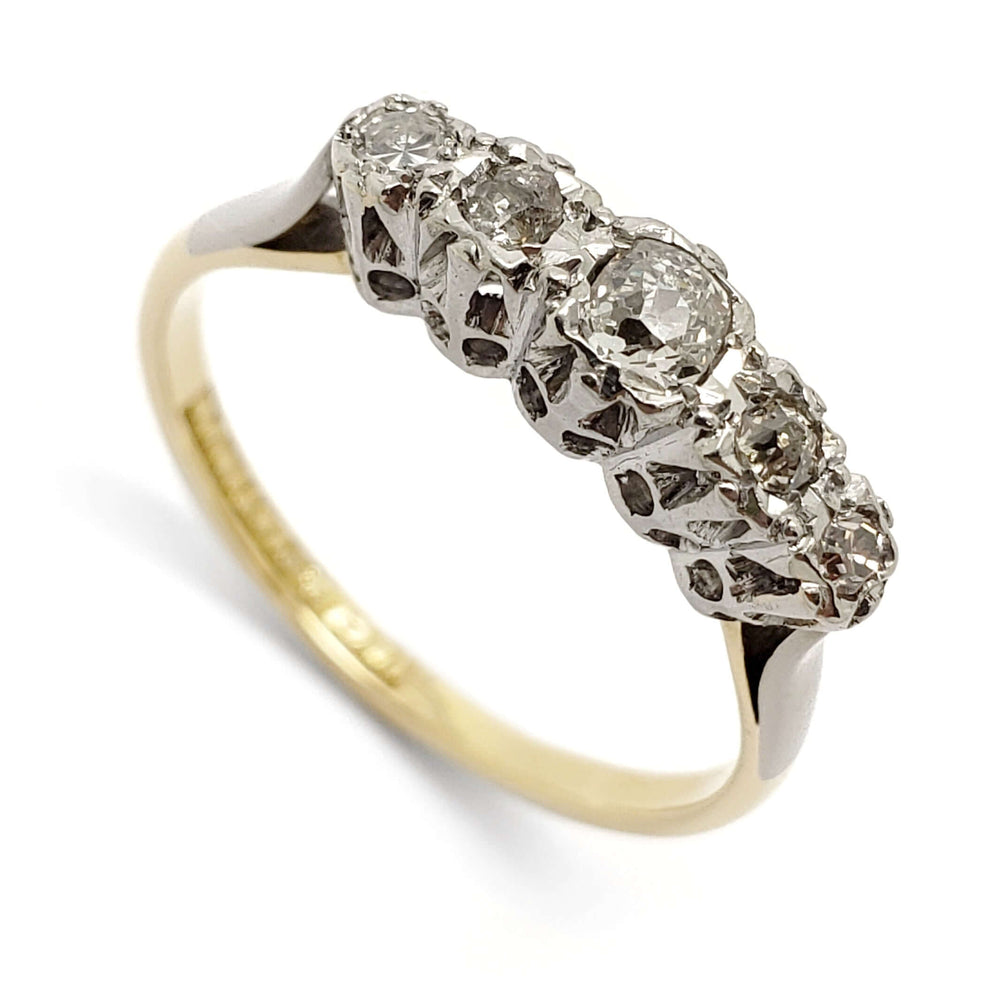 Angled view of antique five-stone diamond ring in platinum and 18kt yellow gold