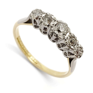 Angled view of antique five-stone diamond ring in platinum and 18kt yellow gold