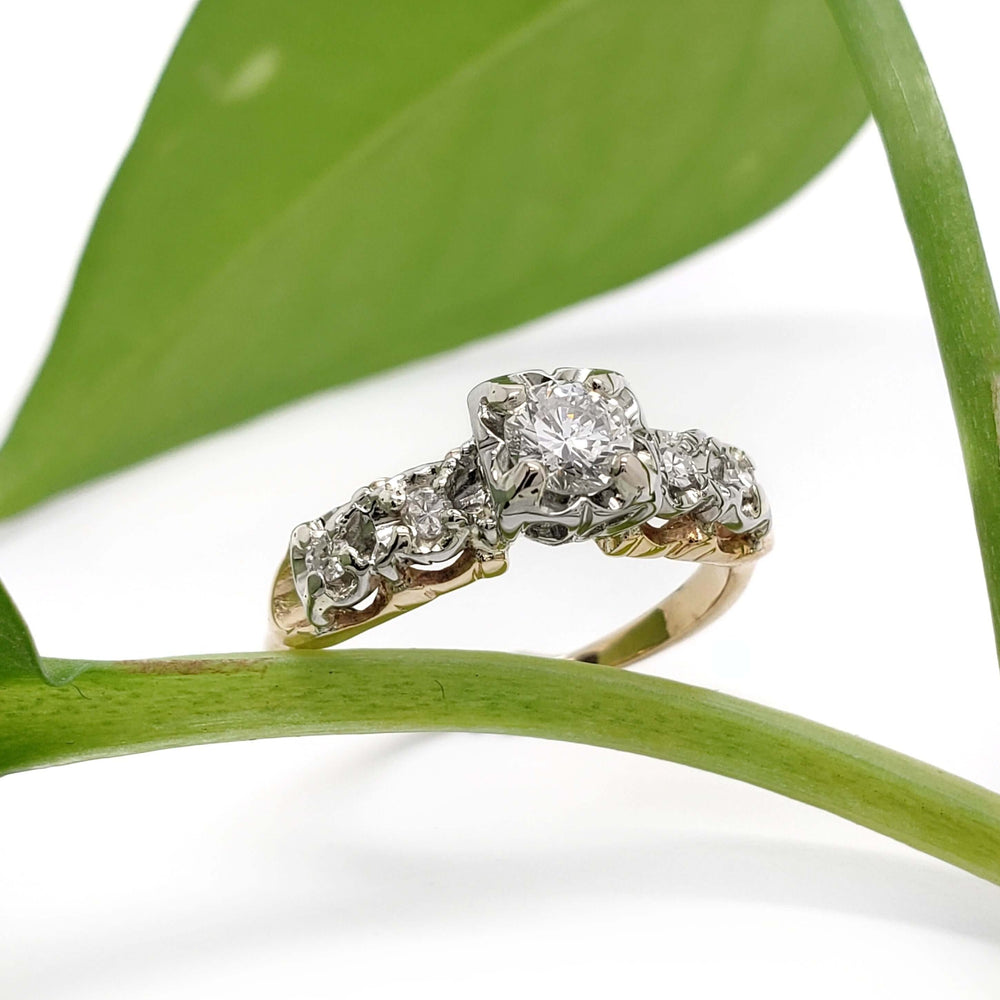 Antique five stone diamond engagement ring in yellow and white gold, with plant accent