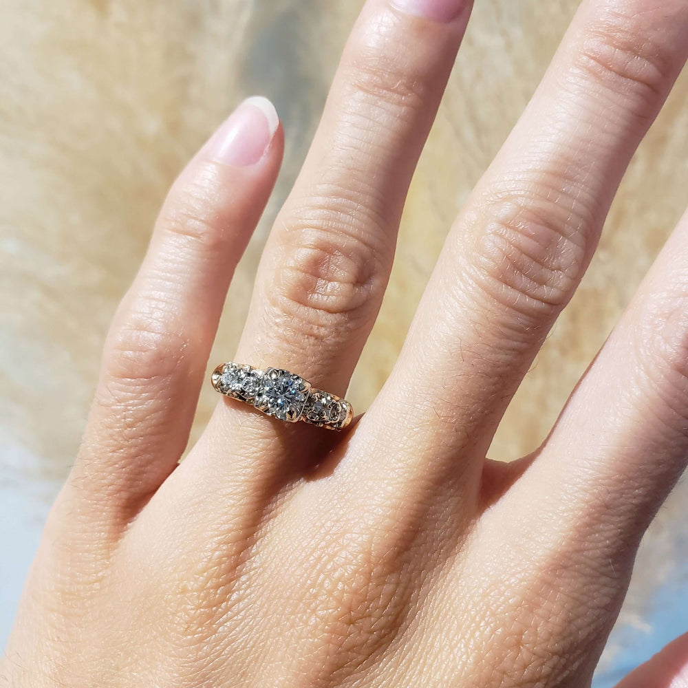 Antique five stone diamond ring in yellow and white gold shown on hand