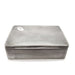 Antique rectangular silver cigar box with textured finish and monogrammed medallion on lid