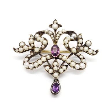 Front view of antique silver brooch with pearls and two oval amethysts