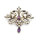 Front view of antique silver brooch with pearls and two oval amethysts