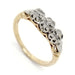 Antique two-tone wedding ring with three round diamonds in white gold settings on a yellow gold band