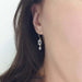 14kt yellow gold aquamarine dangle earring worn on ear