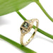 Art Deco inspired 14kt yellow gold ring with green lab sapphire and diamonds, on leaf background