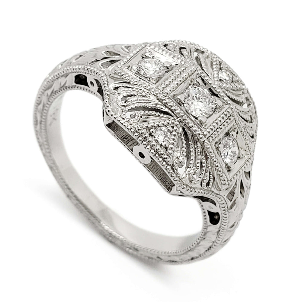 Art Deco style 19kt white gold engagement ring with bead-set round diamonds and millgrain detail